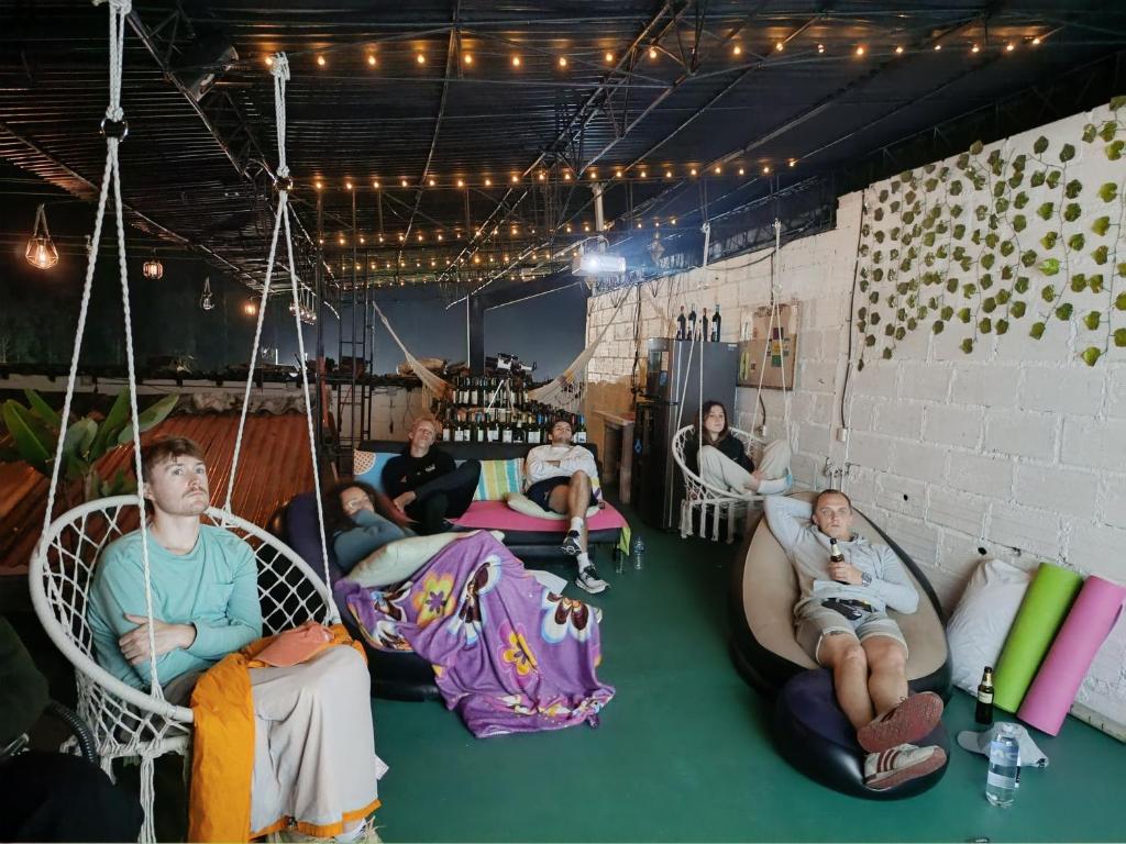 a group of people sitting in swings in a room at Magic Jardín Hostel - Patio, Balcony & Rooftop in Jardin