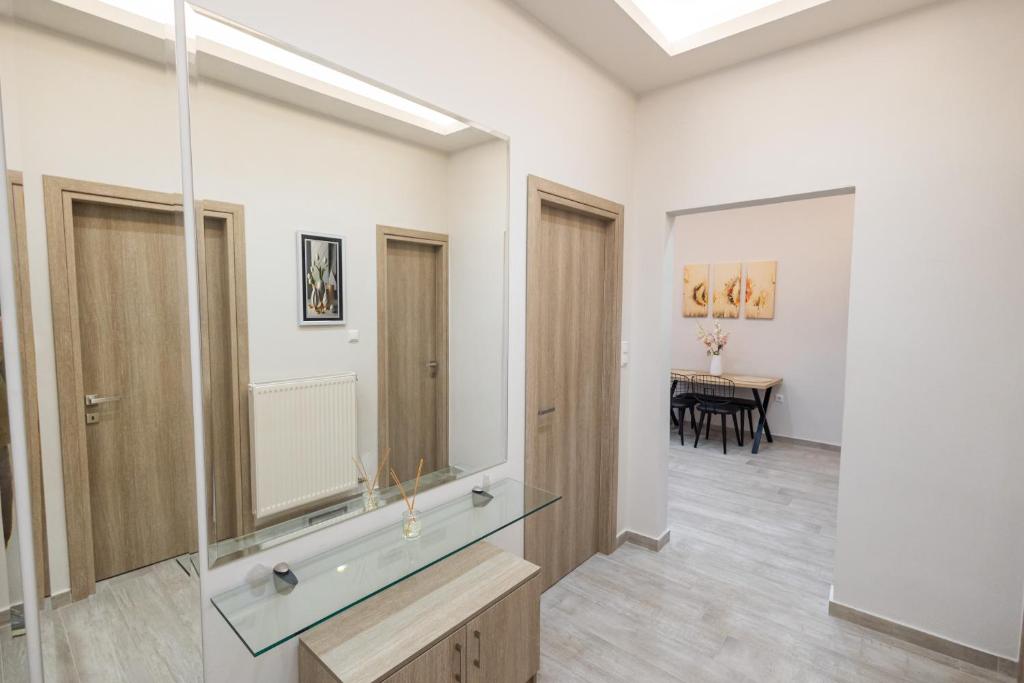 a bathroom with a sink and a mirror at Aurum Residence in Volos