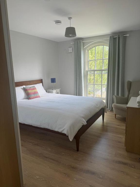 a bedroom with a large bed and a window at Nile Lodge in Galway