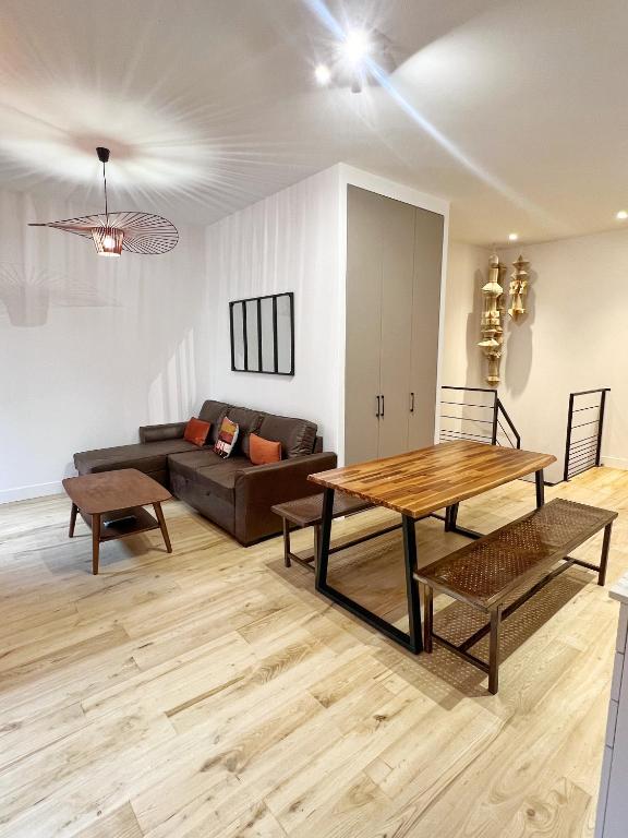 un salon avec un canapé et une table dans l'établissement Le Boutonnier - Centre - Luxe - Terrasse - Clim, à Toulouse