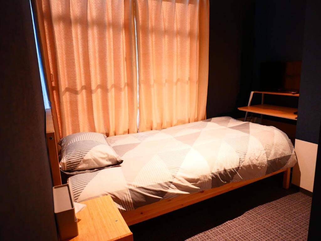 Postel nebo postele na pokoji v ubytování ForYou Honancho 方南町