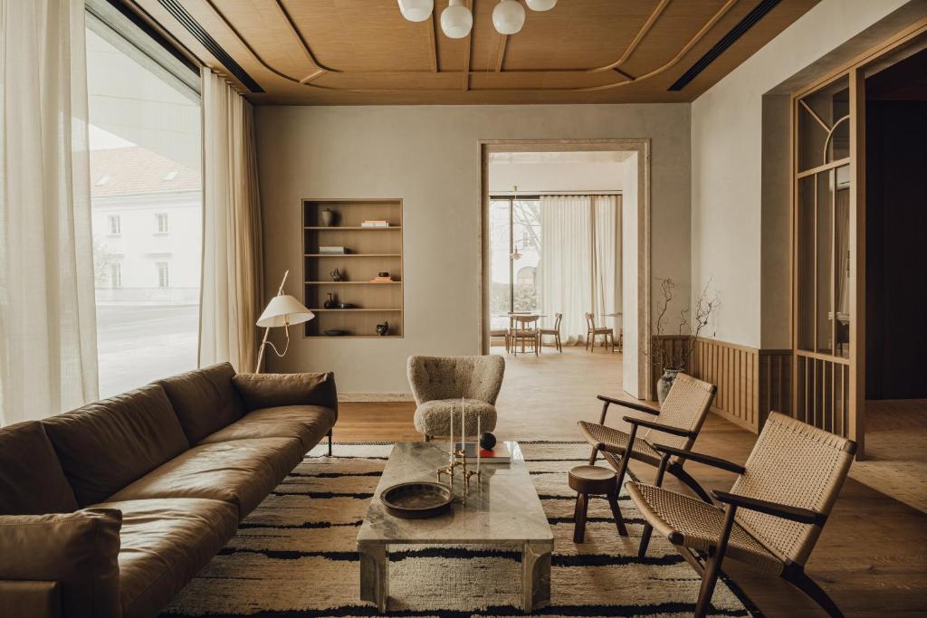 a living room with a couch and chairs at PURO Warszawa Stare Miasto in Warsaw