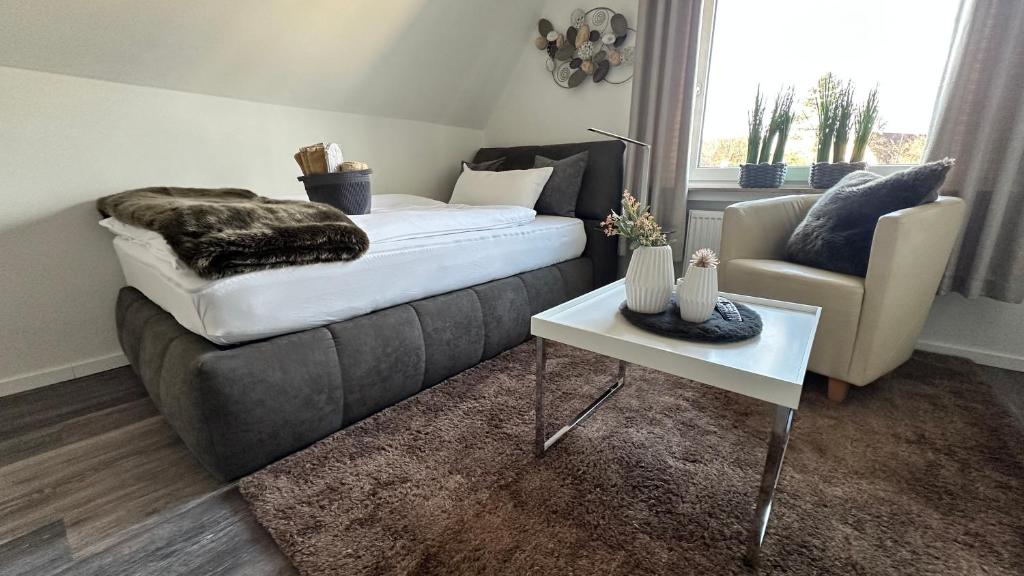 a living room with a couch and a table at HARMONY "2" stylishes 2 Zimmer Apartment 1 OG Balkon Garten Parkplatz in Gütersloh