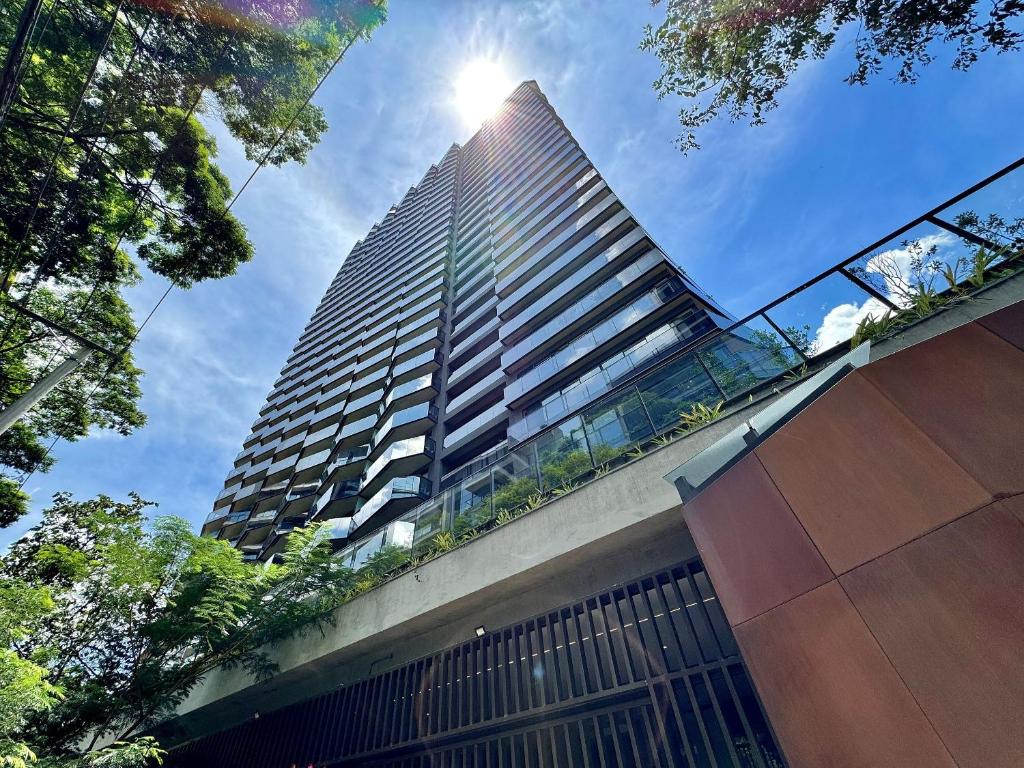 a tall building with the sun shining on it at VN Millennium Faria Lima in São Paulo