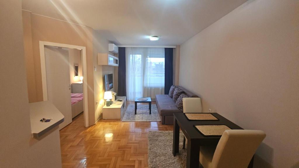 una sala de estar con un sofá y una mesa en Riverside rest, en Niš