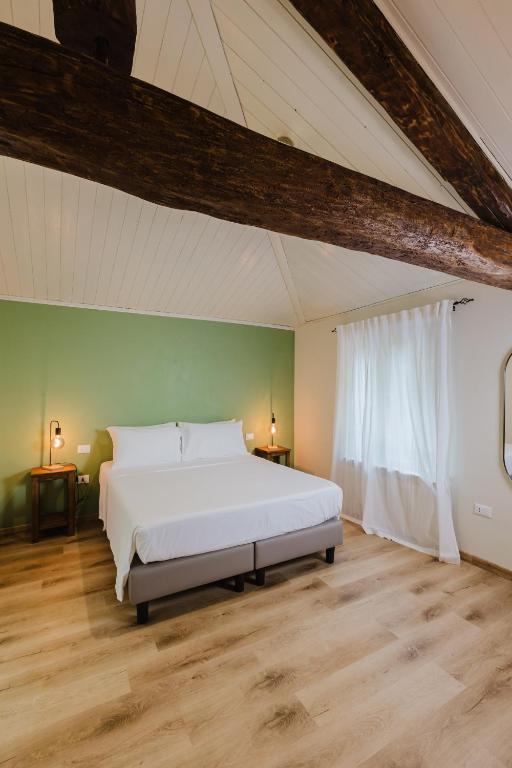 Postel nebo postele na pokoji v ubytování Locanda sul fiume