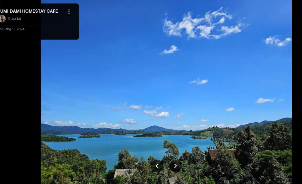 a view of a lake with mountains in the distance at SUMI ĐAMI homestay in Da R'soung