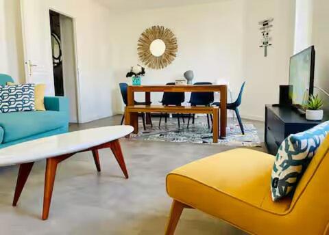 a living room with a couch and a table at Appartement lumineux Côte des Basques in Biarritz
