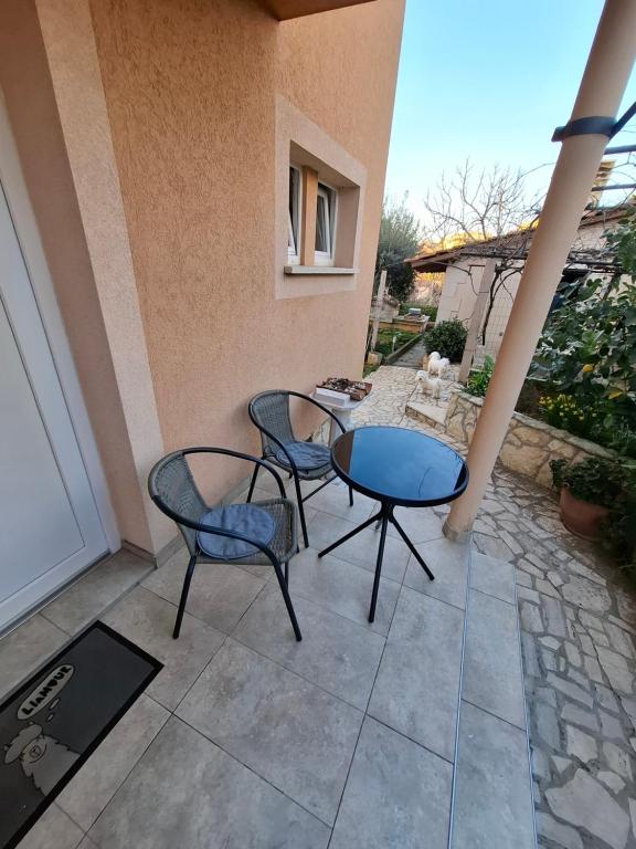 a patio with two chairs and a table at Morena in Pula