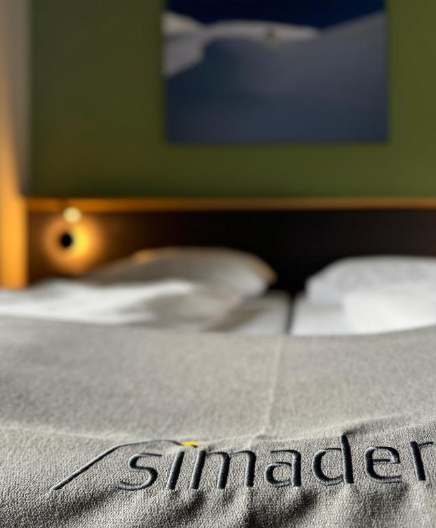 Ein Bett oder Betten in einem Zimmer der Unterkunft Hotel Simader
