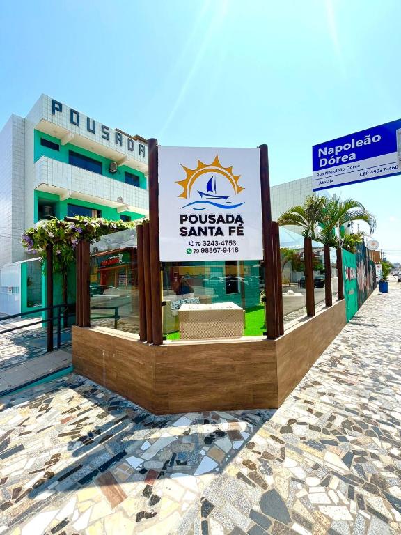a sign for a hotel in front of a building at Pousada Santa Fé in Aracaju