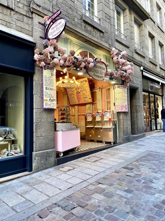 a store front of a store with flowers on a street at T2 dans l'intra-Muros VUE MER exceptionnelle in Saint Malo