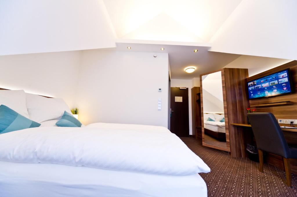 Postel nebo postele na pokoji v ubytování Wohlfühl-Hotel Neu Heidelberg