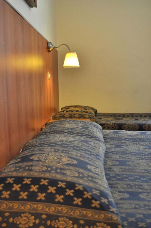 Postel nebo postele na pokoji v ubytování Hotel Fiorenza