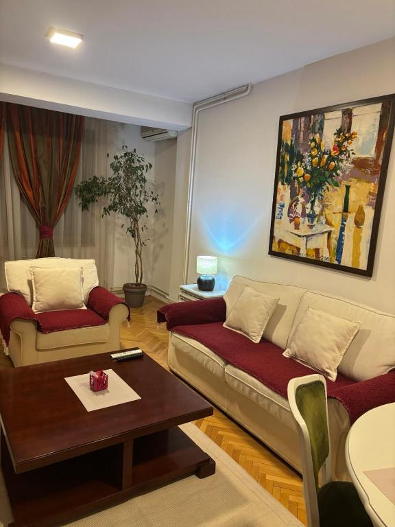 a living room with a couch and a table at Premium 1 One bedroom apartment Maksim Gorki street 8 in Skopje
