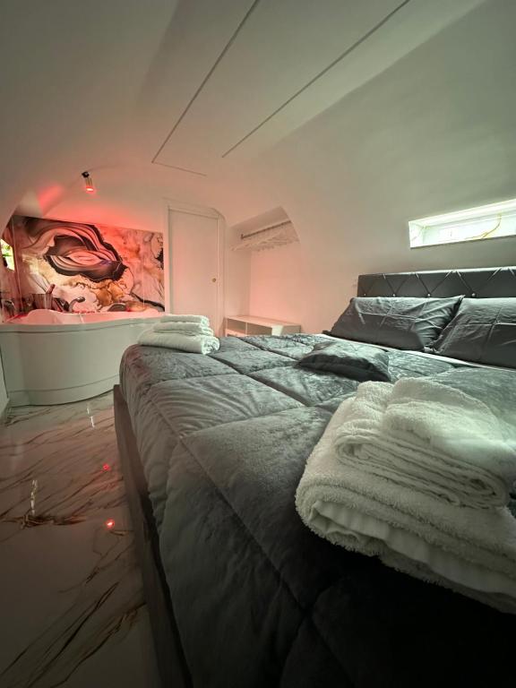 a bedroom with a bed with towels on it at Suite Sanità in Naples