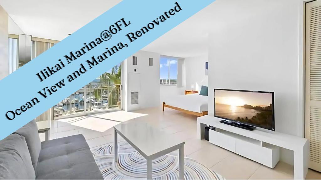 a living room with a tv and a couch at Ilikai Marina 6FL Ocean View & Marina, Renovated in Honolulu
