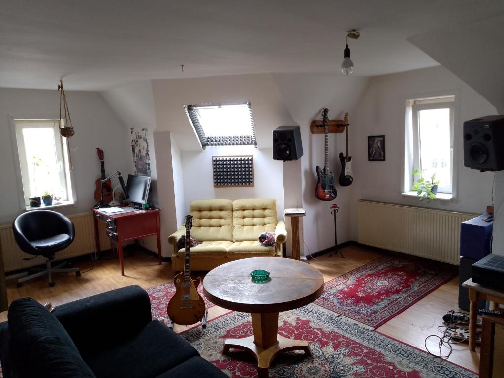 a living room with a couch and a table at Roof-Top View Over Möllevångstorget in Malmö