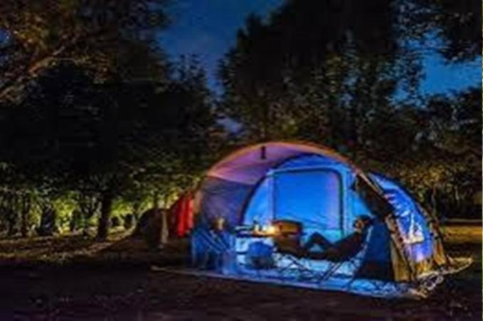 a blue tent sitting in a field at night at NZR KAmP in Serdivan