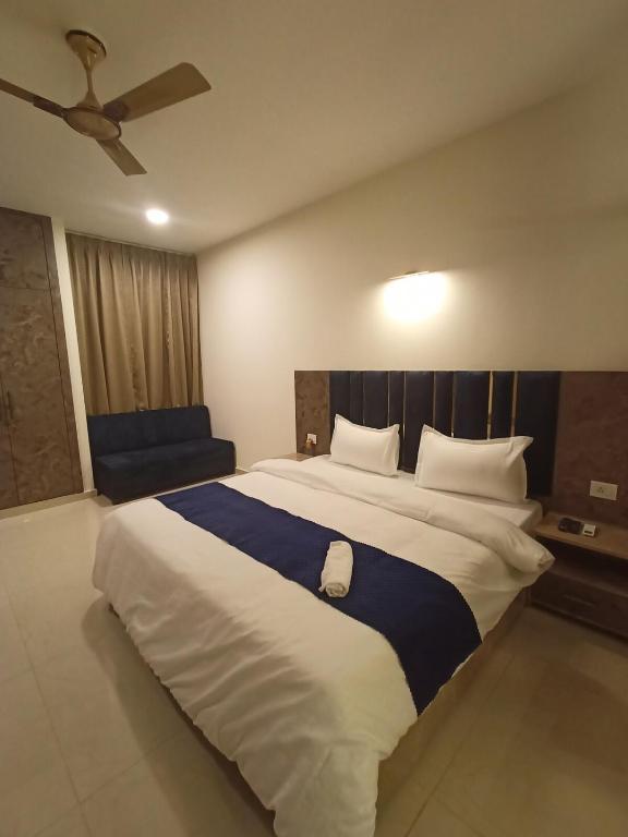 a large bedroom with a large bed with a ceiling at Taj Serenity Divine Luxe Retreat in Chhatikara