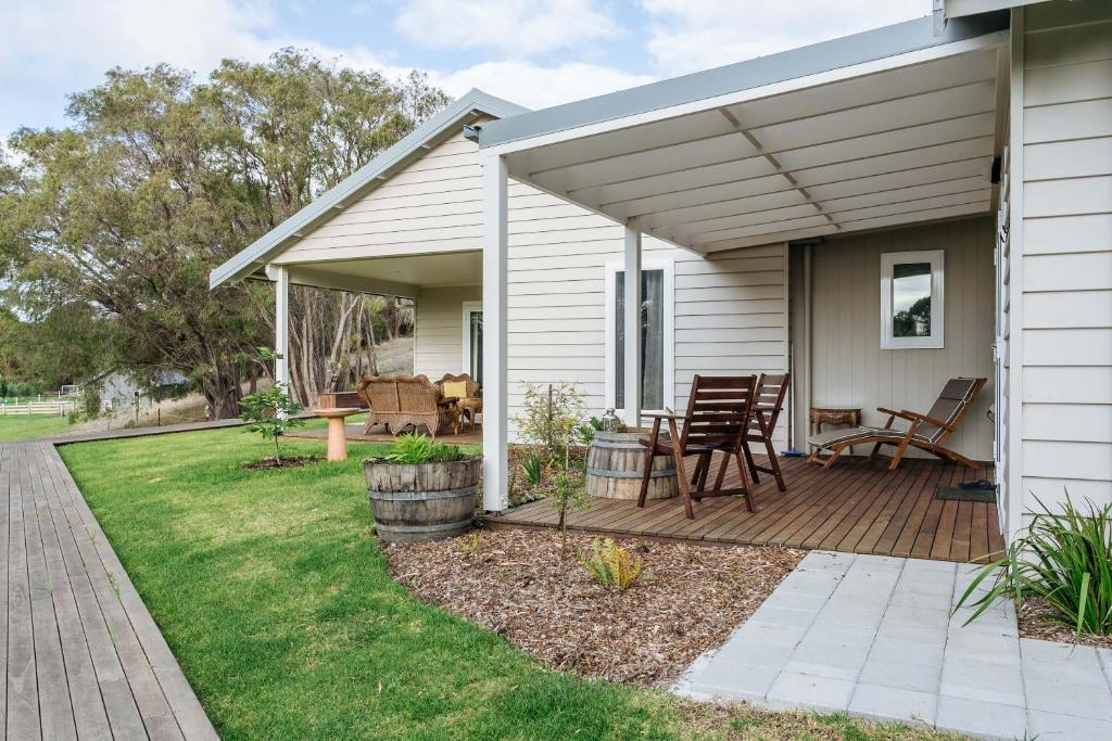 a house with a wooden deck with a table and chairs at Stablebase in Albany