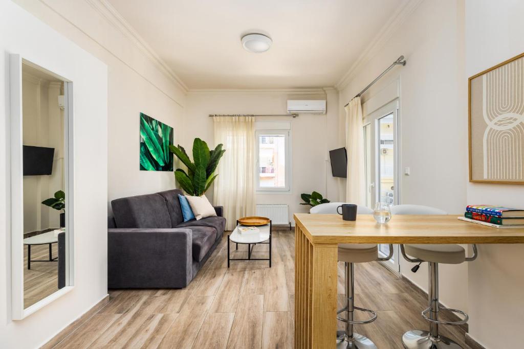 a living room with a couch and a table at Tropical & Faces by Nest in Thessaloniki
