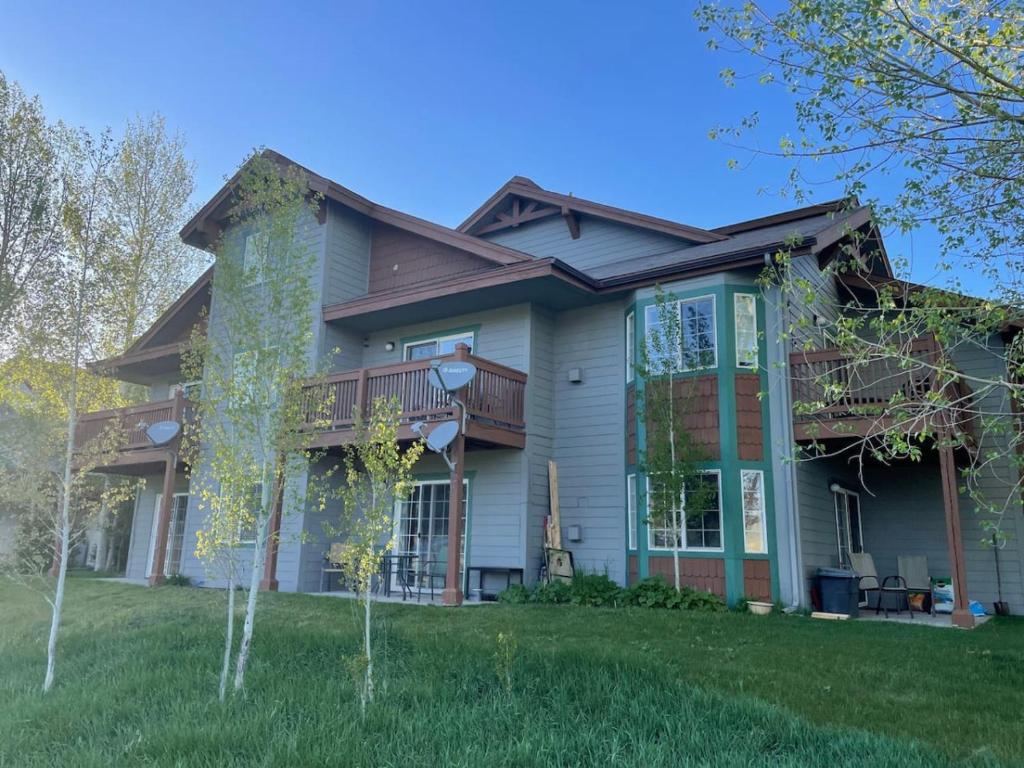 a large house with a deck on a yard at Edwards Mountain Chic On River Pool and Hot Tubs in Edwards