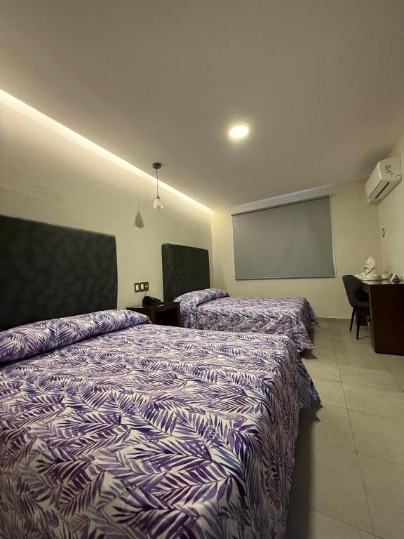 Postel nebo postele na pokoji v ubytování Hotel Impala Veracruz