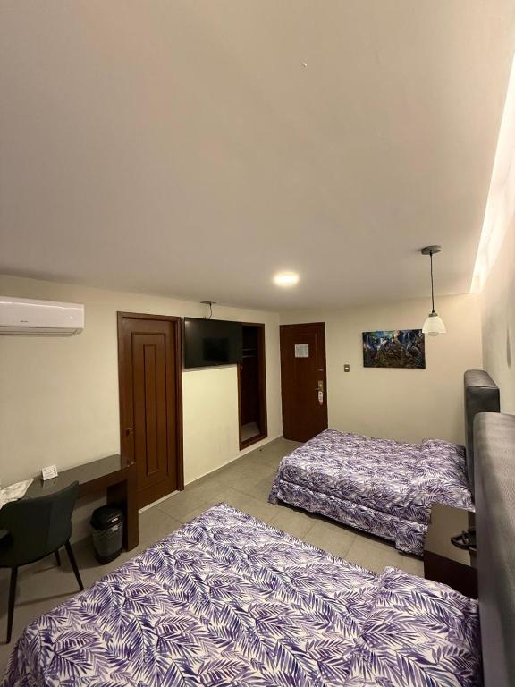 Postel nebo postele na pokoji v ubytování Hotel Impala Veracruz