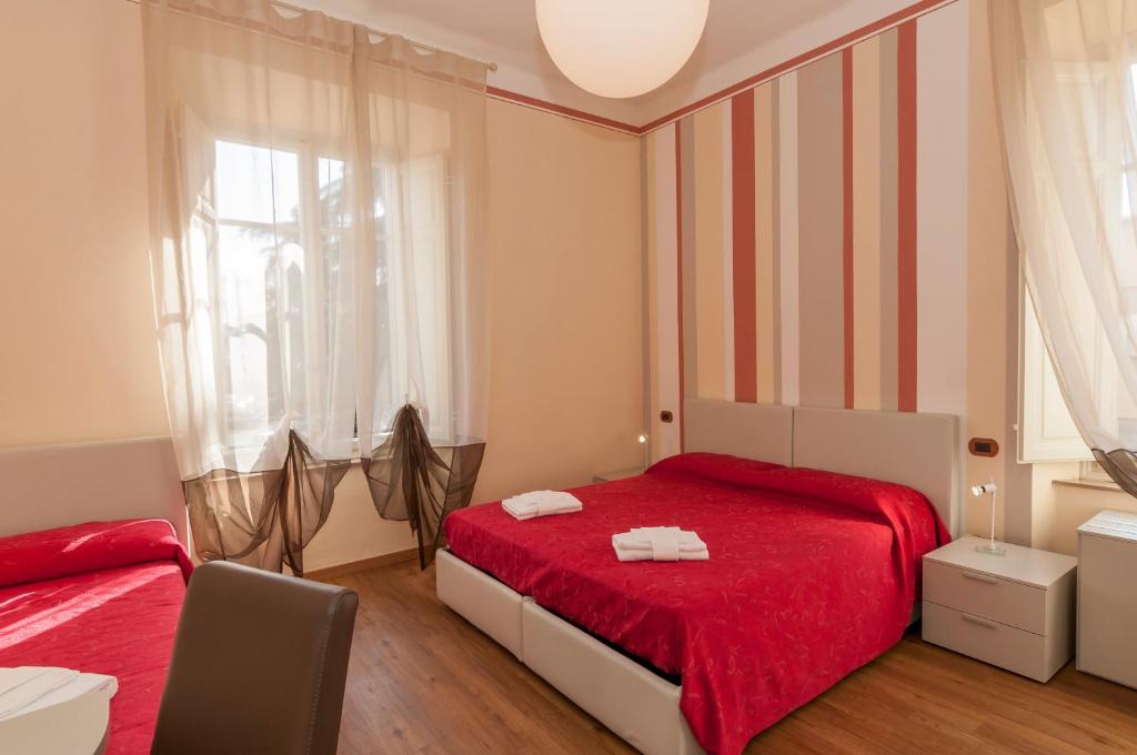 a bedroom with a red bed and a window at Nonna Adriana in Lucca