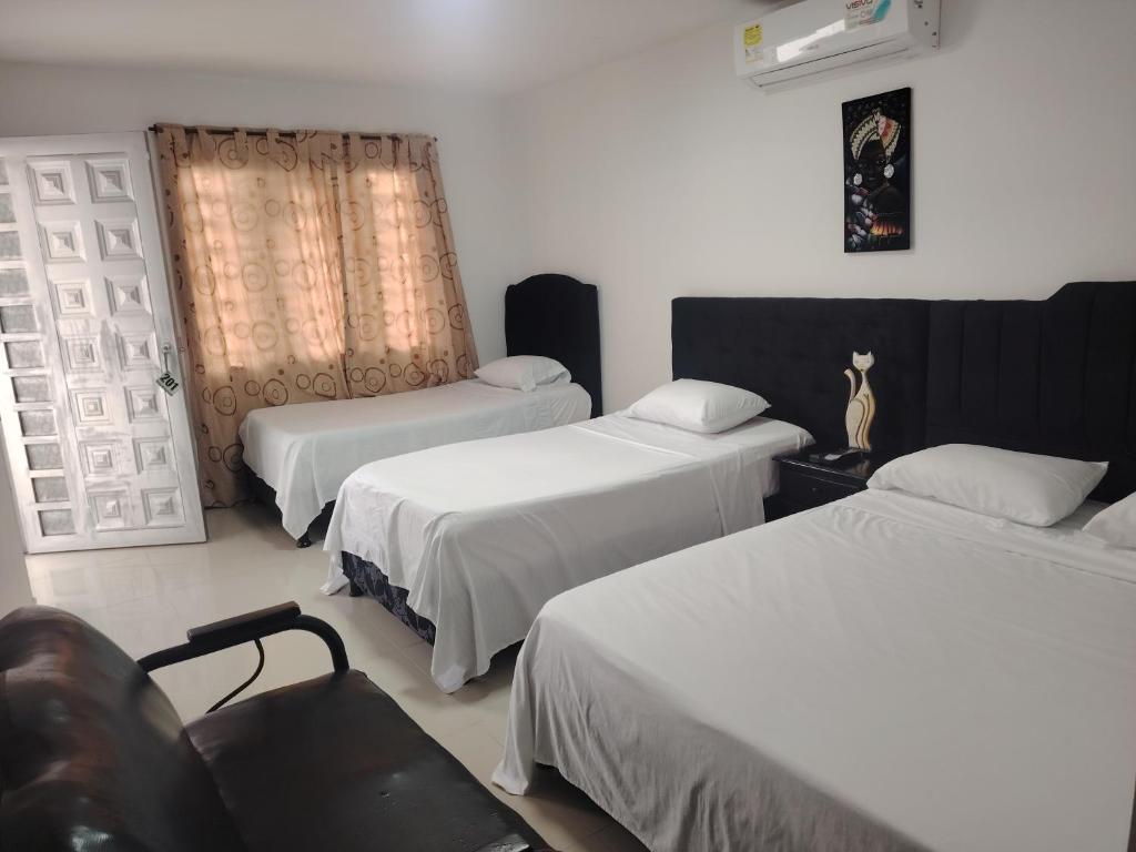 Postel nebo postele na pokoji v ubytování Hotel Palmari