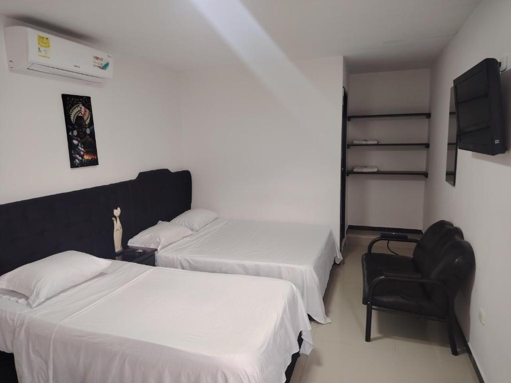 Postel nebo postele na pokoji v ubytování Hotel Palmari