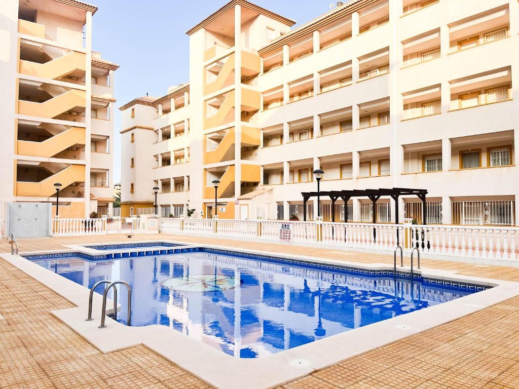 a swimming pool in front of a building at Fantástico Ático Chill Out con Vistas a Mar de Cristal in Mar de Cristal