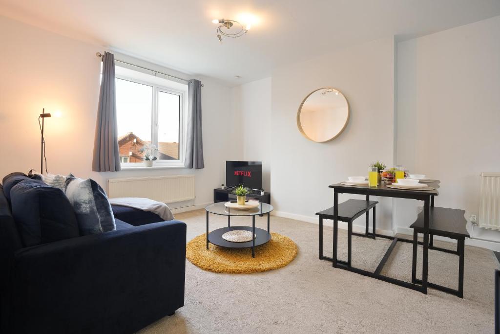 a living room with a couch and a table at Central Sheffield stylish stay in Sheffield