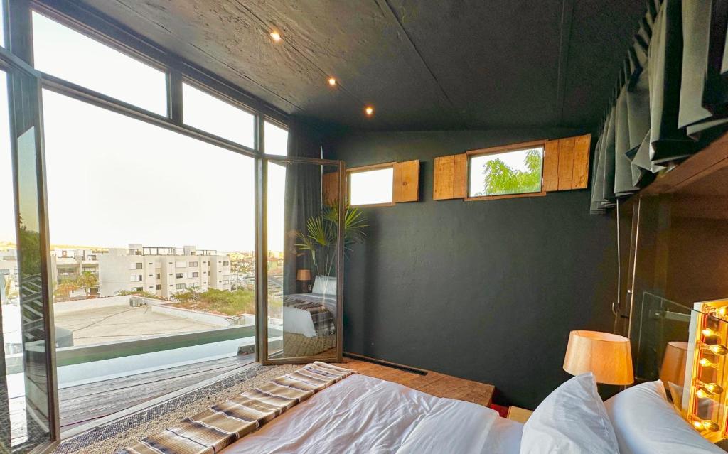 a bedroom with a bed and a large window at 2 Lux Suites in Oasis Compound at The Oliver Cabo in Cabo San Lucas