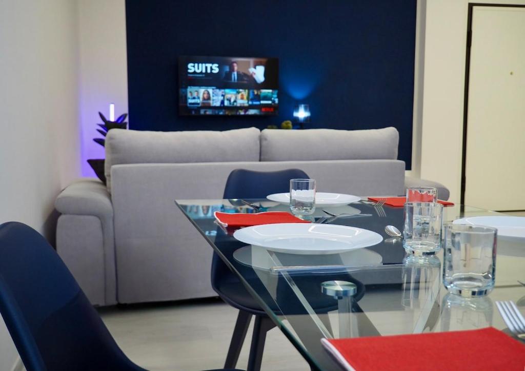 a dining room with a glass table and a couch at Tamerici Salmastre-Montesilvano in Montesilvano