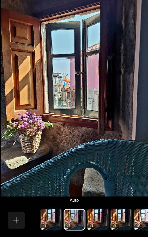 a picture of a window with a view of a bridge at San Roque 52 in Combarro