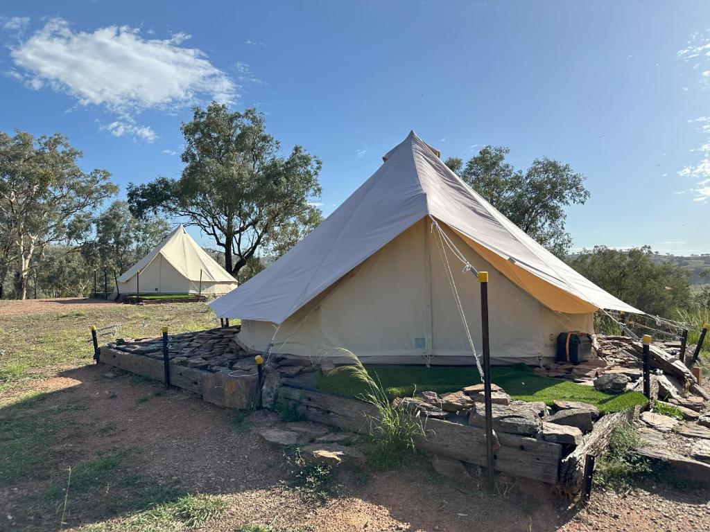 a white tent with a fence in a field at The Stockyard Experience in Mumbil