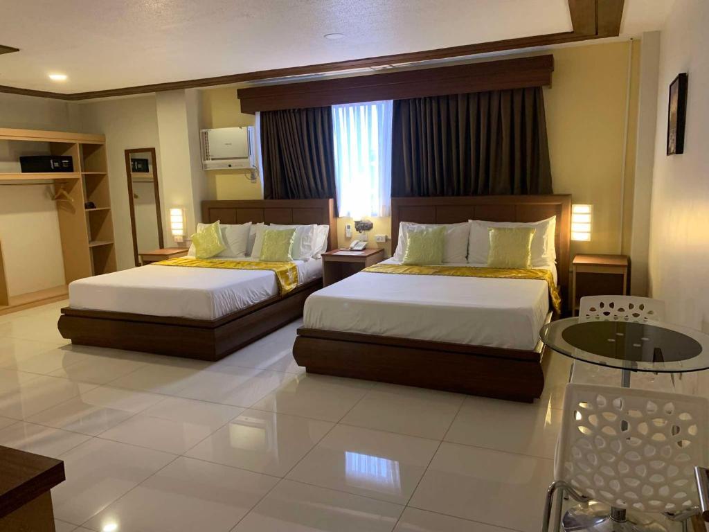 Postel nebo postele na pokoji v ubytování Surigao Royal Regency Suites