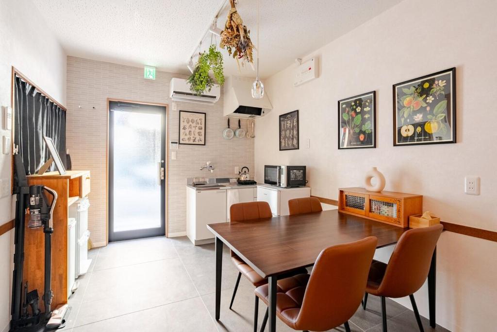 a kitchen and dining room with a table and chairs at Domus OZONE in Nagoya