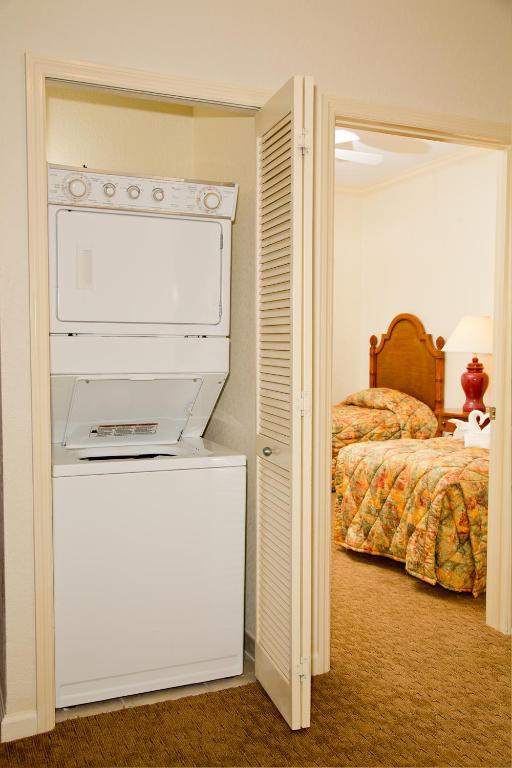 a room with a bedroom with a bed and a printer at Lake Buena Vista Resort Village and Spa, Near Disney in Orlando
