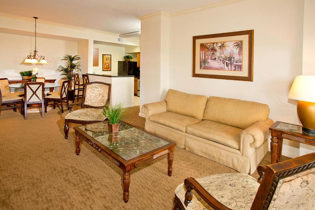 a living room with a couch and a table at Lake Buena Vista Resort Village and Spa, Near Disney in Orlando