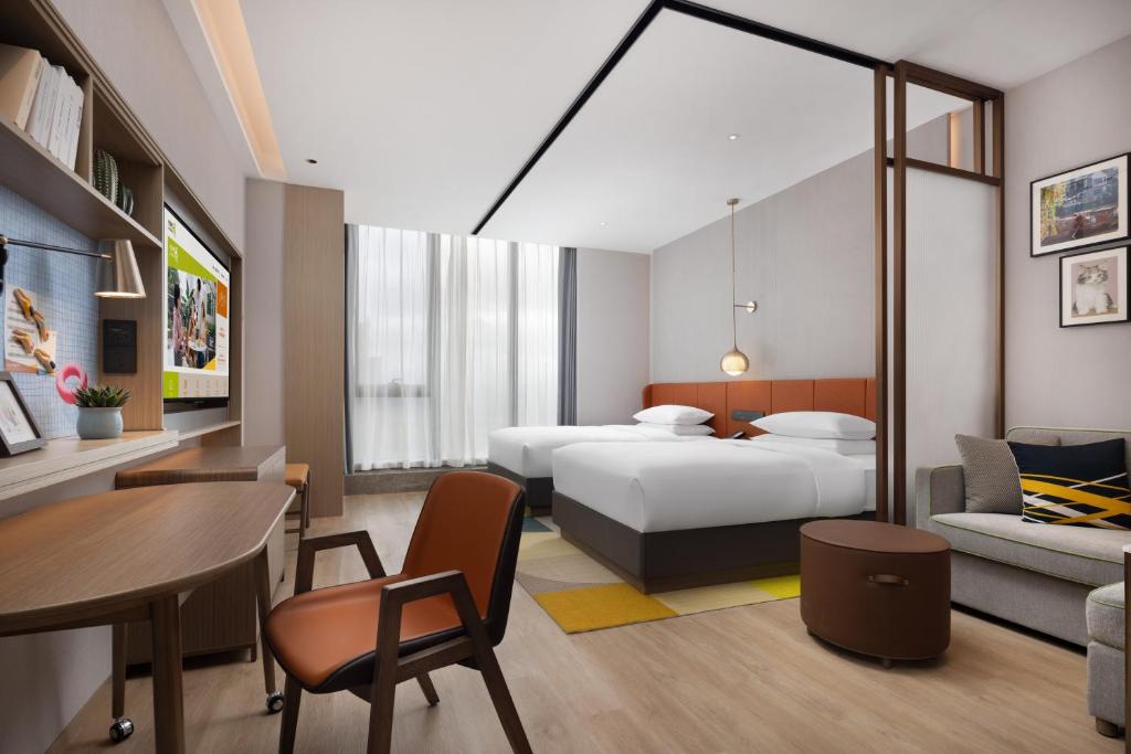 Voodi või voodid majutusasutuse Home2 Suite by Hilton Yiwu World Trade Center toas