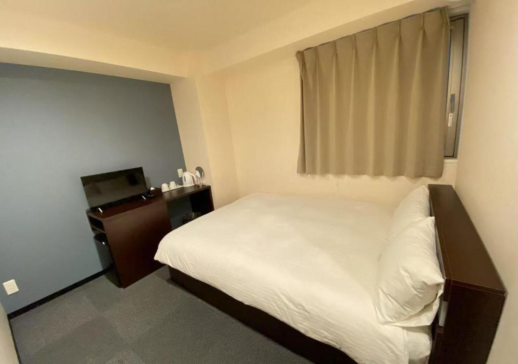 Postel nebo postele na pokoji v ubytování Floral Hotel · SakaisuJi-Honmachi Osaka