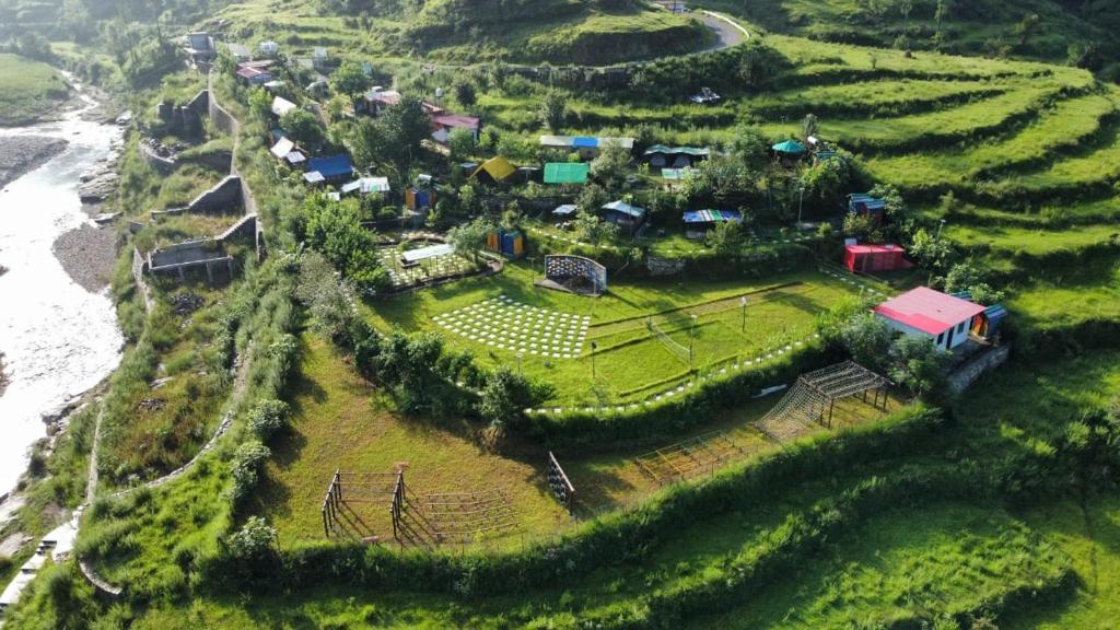 a small village on a hill near the ocean at Nisarg Camping Pods in Almora
