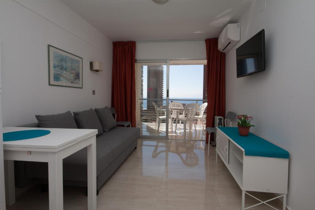 a living room with a couch and a table at Apartamentos Niza in Benidorm