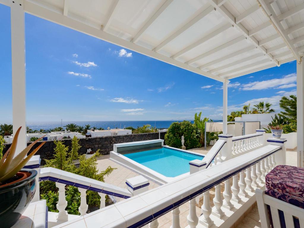 a pool on the balcony of a house at Villa Fortuna in Puerto Calero