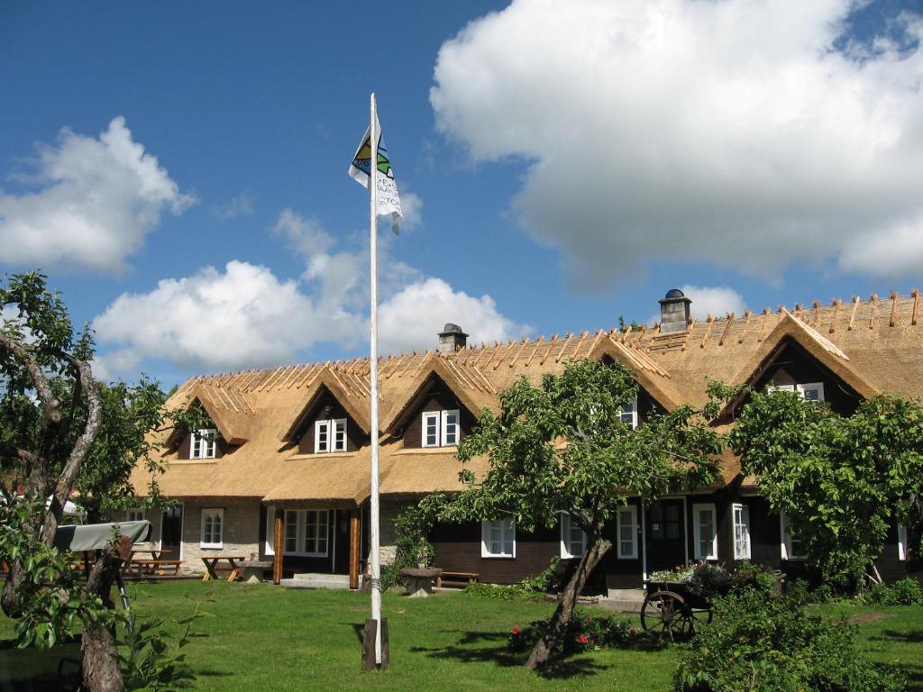 a flag pole in front of a large house at Jurna Recreation Farm in Upa