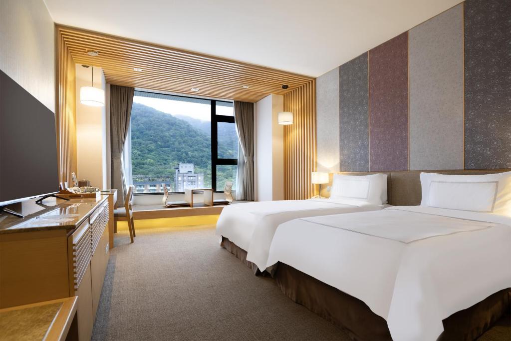 Postel nebo postele na pokoji v ubytování Evergreen Resort Hotel - Jiaosi