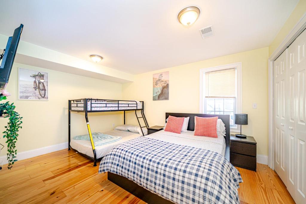 a bedroom with a bed and a bunk bed at Stunning 3BR Quincy Home w Laundry, Bathtub, near Red Line & Adams NHP 39 in Quincy